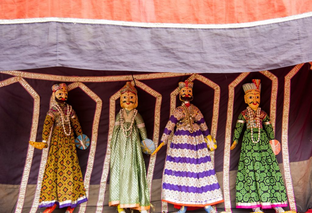 Puppets on the wall for sale on street of Jaipur